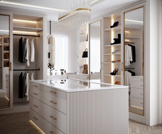 Walk-in wardrobe with white cabinetry, fluted center island, and gold accents, luxury property interior Solihull apartment interior design in West Midlands