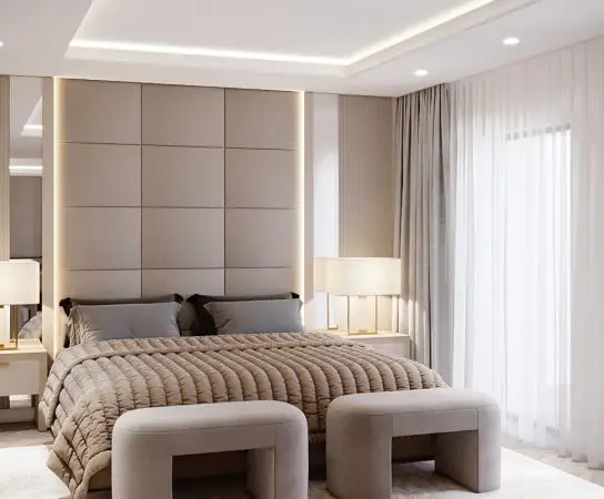 Master bedroom with a large upholstered headboard and soft neutral tones, elegant home design West Midlands apartment interior design in West Midlands