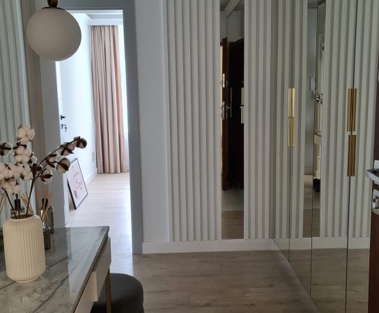 Hallway with feature wall and mirror-door wardrobe - modern interior design in Warsaw