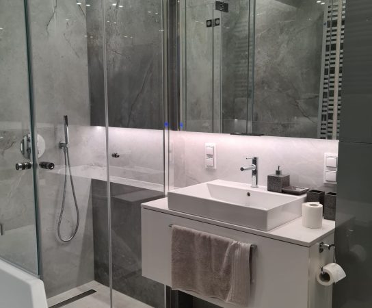 Bathroom - cozy, neutral colours, grey shiny tiles and shower and bath - - Modern Apartment interior design in Warsaw, Poland