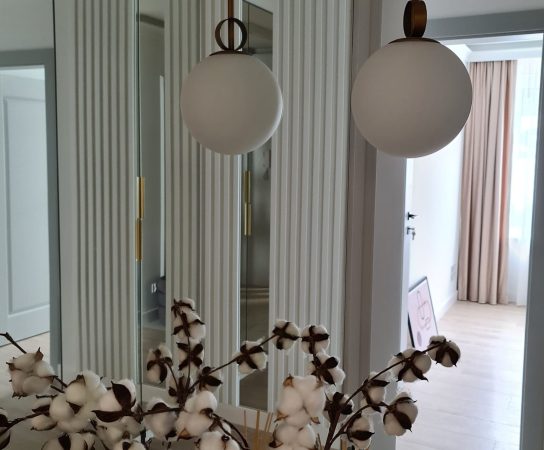 Hallway with pendant lamps and mirror door built in wardrobe, modern apartment interior design in Warsaw