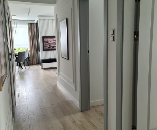 Long Hallway with wooden floor and false ceiling, modern interior design in Warsaw