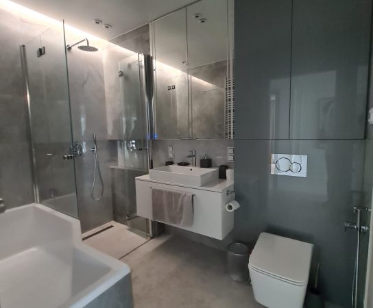 Neutral bathroom in grey and beige colours - modern apartment interior in Warsaw