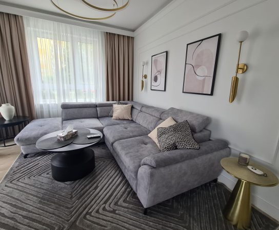 Cozy living room in neutral clours with grey sofa and beige curtains - Modern Apartment interior design in Warsaw, Poland