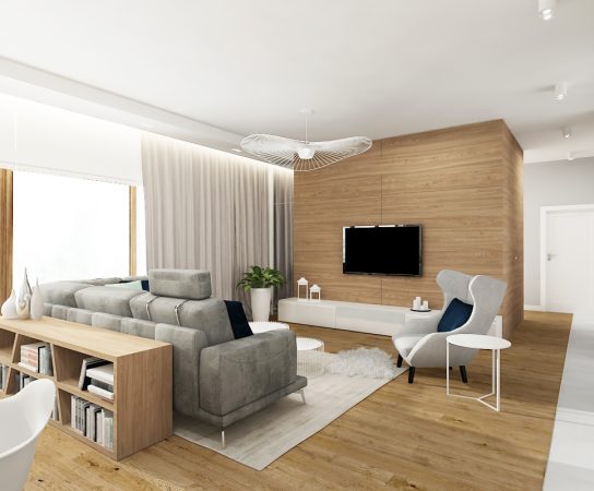 Modern living room, grey sofa, wood feature wall, white armchair, light wood floor, ceiling fan light.