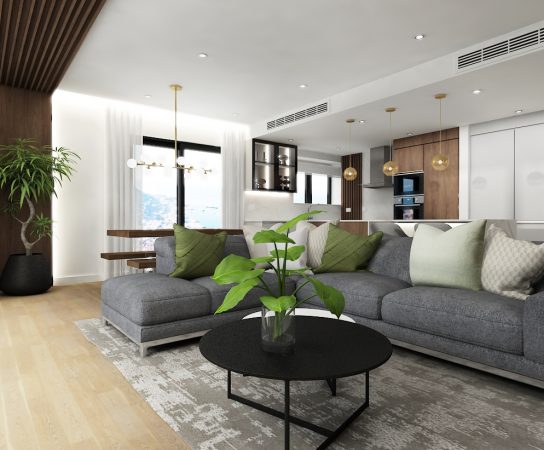 Open plan living room / kitchen with grey large sofa and black 2-part coffee table, modern apartment design Gibraltar