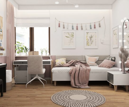 Detail of built-in wardrobe and desk in a child's bedroom in Warsaw, featuring white cabinets and pink accent shelves.