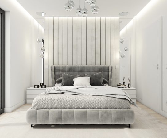 Primary bedroom in a minimalist Dubai villa featuring a gray velvet upholstered bed, vertical panel headboard, and ambient cove lighting.