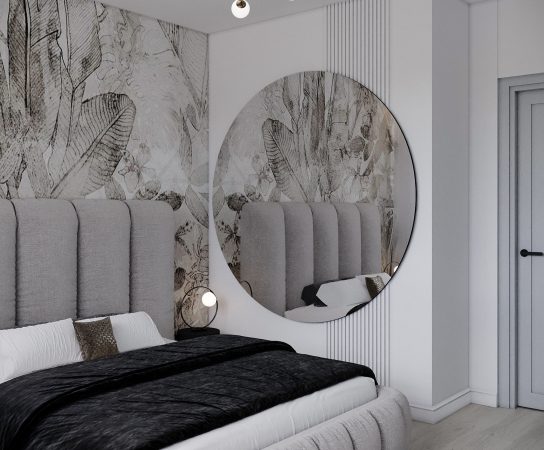 Modern apartment bedroom with a circular mirror reflecting the grey headboard, and vertical slatted wall panelling detail.