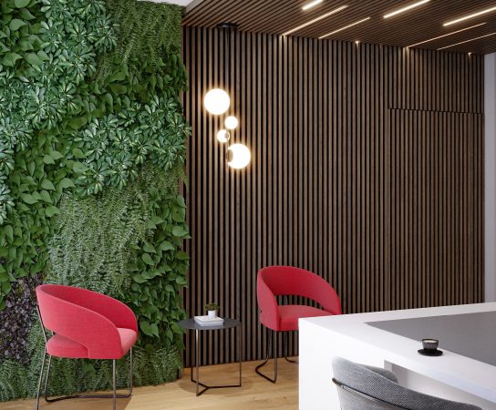 Minimalist office reception desk with two red high-back executive chairs and the Big Mommas Housing company logo on a light gray wall.