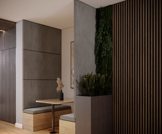 Office interior with private booth seating, a small wooden table, and a built-in planter with green plants, next to a dark wood slat wall.