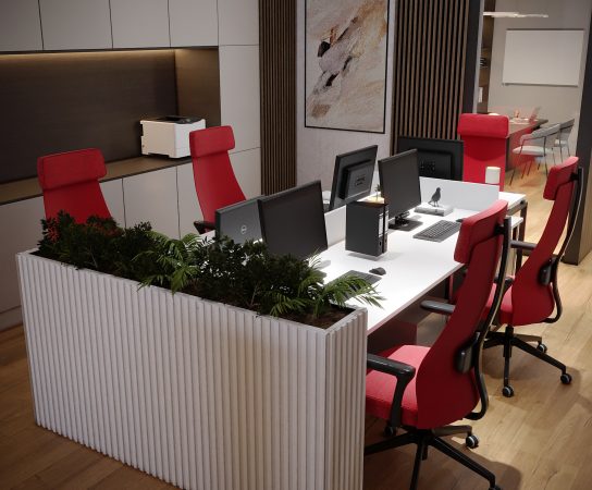 Open-plan office workstation with a white desk for multiple users, red ergonomic chairs, and a white slatted planter box as a divider.